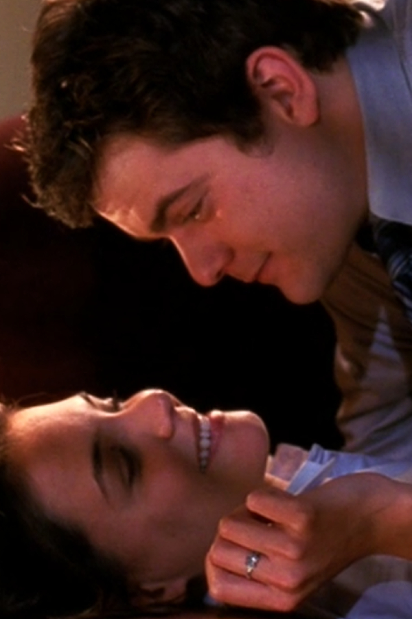 A sideways shot of Pacey and Joey grinning and pre-makeout on Pacey's office couch