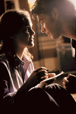 A warmly lit close-up of Felicity and Noel about to embark on a major kiss mid-Boggle game