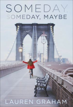 A woman in a red coat rides a bike on the brooklyn bridge