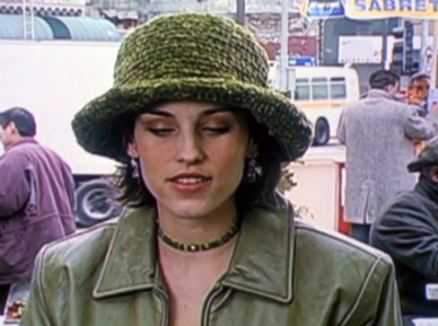 Julie in an olive green crushed velvet bucket hat that matches her olive green leather jacket