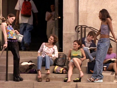 Meghan, Felicity, Julie and Elena, all in awesome clothes and looking cool and relaxed, hang out on steps outside UNY