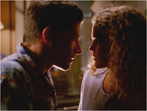 Felicity and Eli, very close to kissing, bathed in shadow and looking hot