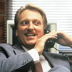 Principal Rooney (FERRIS BUELLER'S DAY OFF) grinning while talking on the phone
