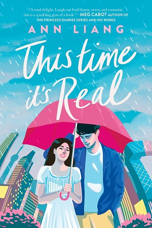 Cover of This Time It's Real by Ann Liang: Illustration of a Chinese girl and boy smiling and standing under a red umbrella against a bright but rainy backdrop of the Beijing skyline