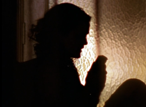 The classic FELICITY silhouette: Felicity sits in shadowy profile, holding up a tape recorder