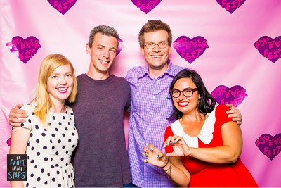 Sarah standing next to director Josh Boone, author John Greene, and Brandy, the other festival director, against a pink background with hearts