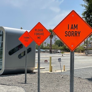 A row of signs that read I am sorry, please forgive me, and thank you