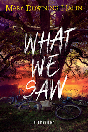 Cover of What We Saw, featuring a large tree in front of a sunset with bikes littered around the base