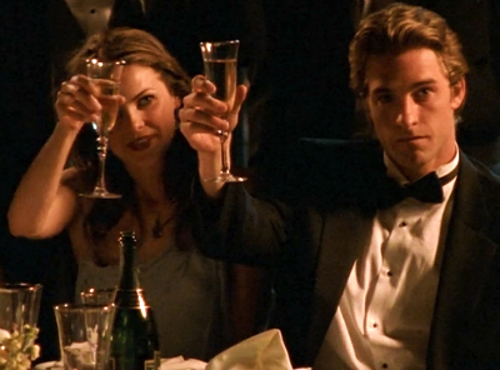 An updated version of our usual drinking game picture, this time with Felicity and Ben from the finale, both in formal attire and holding up champagne flutes in a toast