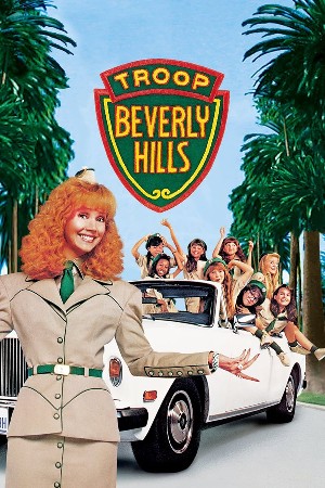 Poster for Troop Beverly Hills, with a redhead Shelley Long wearing a tailored khaki uniform with a fancy car full of a troop of girls behind her