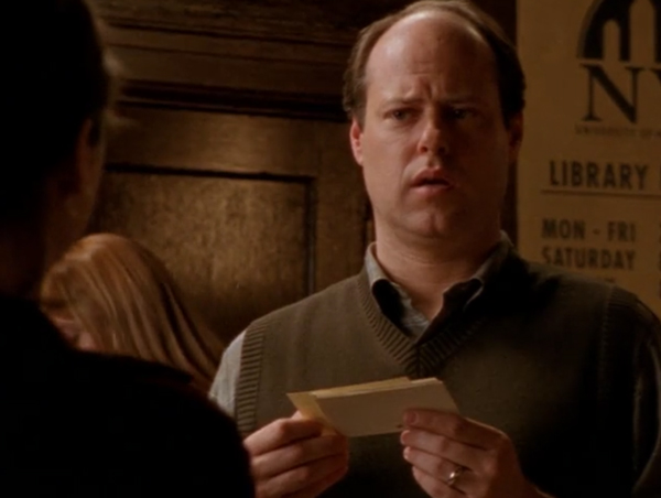 David Bowe, a balding middle aged white man, holding cards and looking confused