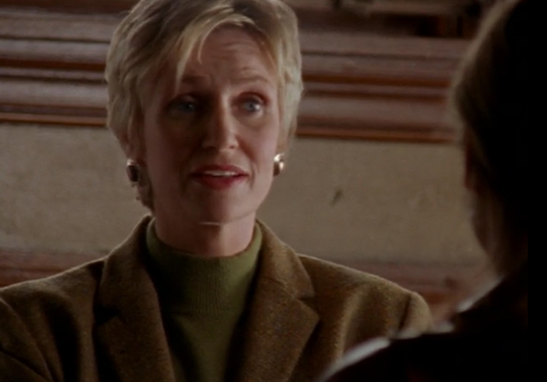 Jane Lynch, a white woman with short blonde hair in a turtleneck and blazer