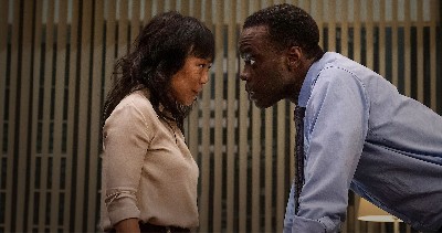 An Asian American woman with long hair faces off with a Black man in a blue shirt