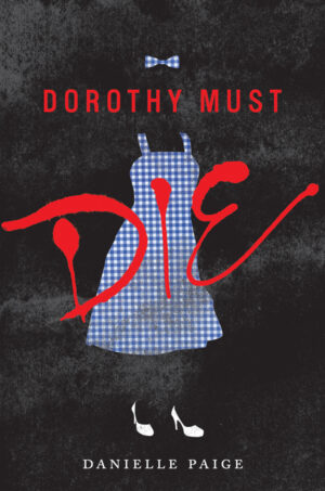 Cover of Dorothy Must Die, featuring a blue gingham dress and hair bow and white heels on a black background