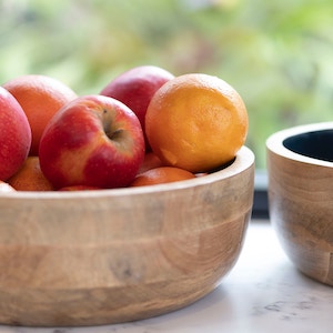 Apples and oranges in a wooden bowl