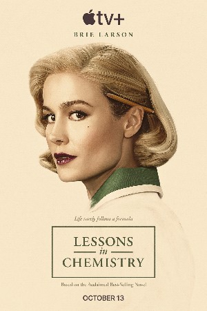 Poster for Lessons in Chemistry, with the face of a pretty blonde woman (Brie Larson) looking at the viewer with a pencil tucked behind her ear