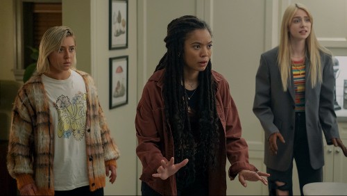 Three young women in a room looking nervous: a blonde white girl in a t-shirt, a pretty Black girl with braids, and a model-esque blonde with long hair in a blazer