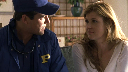 Coach and Tami Taylor sit on the couch in great lighting, looking solemnly at each other