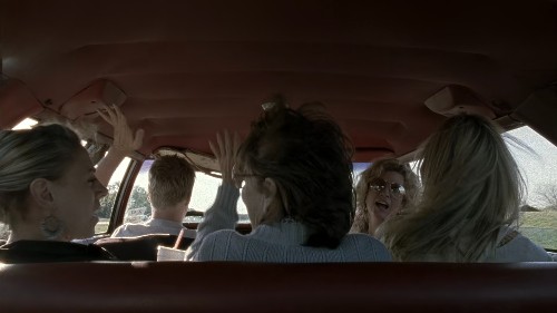 A group of women in a car singing and having the BEST time