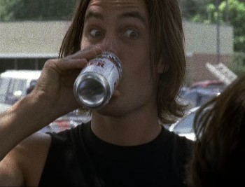 Tim Riggins, a hot white dude with shaggy brown hair, drinks a beer with his eyebrows raised