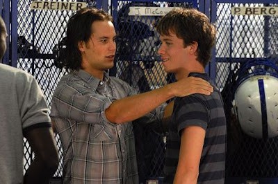 Tim Riggins has his hands on a smiling J.D. McCoy's shoulders in the locker room